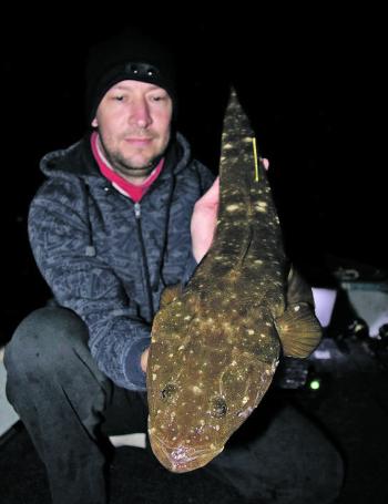 Mark Masters with a flathead which he caught working a canal rockwall.