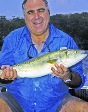 The author with q Pittwater salmon, They’re great fighters but he’s not so sure about the eating qualities.