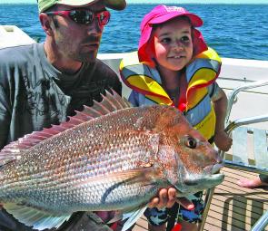 Josh Dentry and son Fraser with a 77cm snapper caught on a 2kg squid outfit in the middle of the day. Snapper was released. Pics courtesy Josh Dentry