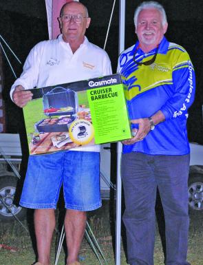 John Trigg receives his second place prize from Bruce Nash from Nashy’s Compleat Angler in Mackay.