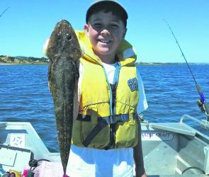 Sam Sherriff with a southern blue spot flathead caught from the Tamar River.