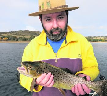 Luke Taylor holds up a beautifully colourful trout! 