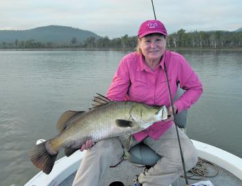 Denise Kampe with a decent fly caught barra from Lake Proserpine. (“You can lift it! That fish is only 17kg!”)