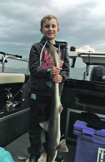 Ryder Thompson with a nice gummy caught during the run out tide on salmon fillet.