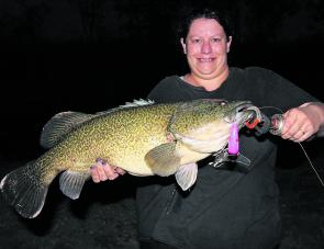 Lauretta Alexander with a magnificent cod caught on a Koolabung surface lure cast from the bank after sunset. This cod is possibly a Murray cod-trout hybrid. The two species have been known to cross breed, but it is not common and the hybrids are sterile.