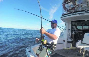 Hooked up! Mark Bain gets stuck into his striped marlin on Better Than Vegas. (Photo courtesy of Peter English)