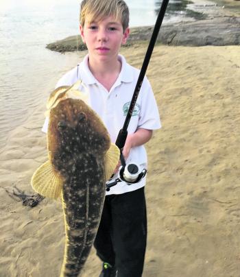 Ethan with a Tomakin flathead that’s almost as big as he is.