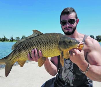 Local angler Ryan with a solid soft plastic caught carp from Albert Park. Photo courtesy of Ryan Cohn.