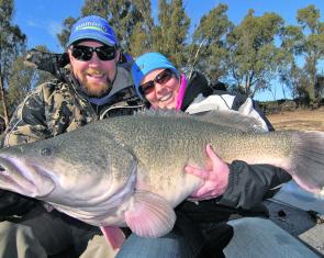 Ray Clifford helps Felicity Cocks hold her PB cod that she caught on the Murray River trolling a lure. 
