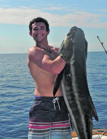 James Rosman with 40kg of cobia trolled up wide of the Sandy Cape Lighthouse.
