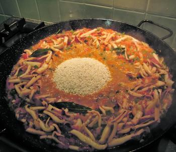 Add the rice. Sauté the rice to coat it, and mix it in well with squid mixture.