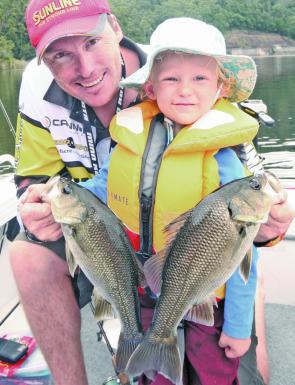 Kevin Walmsley, 3, and his Dad with a double hook-up of chunky Clarrie Hall Dam bass caught on soft plastics.