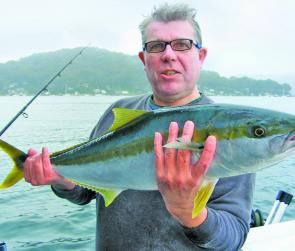 Neil McCauley with his hard-fought 86cm kingfish, caught on a plastic under a raft of jellyfish.