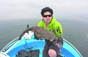 Lachie Ma with his PB flathead. The big girl went 77cm and fell to a Keitech soft plastic. The fish was released after the pic.