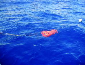 Using a sea anchor helps to slow you down when drifting. Note the ropes: tight rope, the trip rope and the trailing rope that goes to the float.