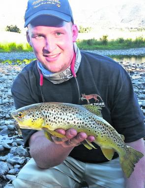 Brenton Richardson with a lovely Kiewa River brown trout taken on a Strike Tiger T-tail minnow. 