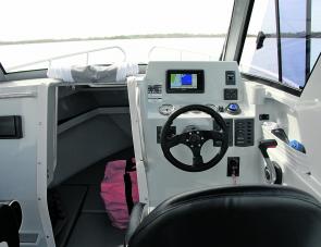 The 610 Cuddy Cab Hardtop major helm/dash features, from glove box to the sensible dash layout, are easily noted in this image. 