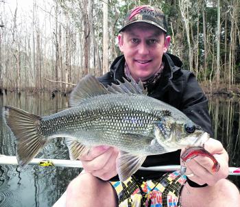 Jay Noble looking happy with a decent bass. When it comes to fishing the sticks, spinnerbaits and weedless plastics are excellent options.