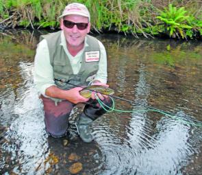 Graham Thwaites with a nice small stream trout in calmer conditions.