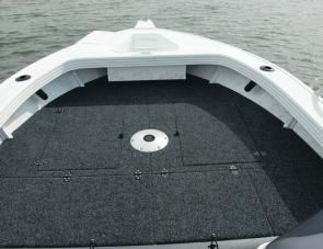 Neatly finished carpet work and hatches up on the casting deck are features of the Clark Dominator. Note the large anchor well.