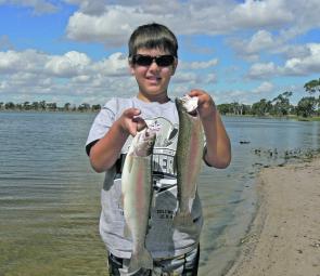 Curtis Vanstan and two rainbows he caught at Natimuk Lake.