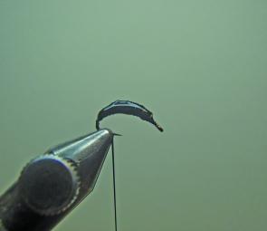 Place the hook in the vice and take a section of lead wire. Wind the lead wire on towards the bend then back to the eye stopping a little shorter each tine until you finish on top of the bend in the hook. Apply a good drop of superglue to the wire and the