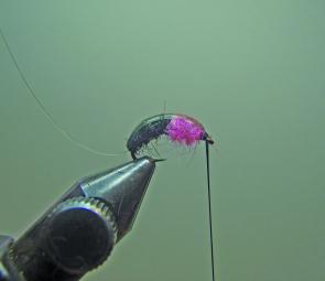 Take a dubbing brush or pick and tease out the pink fibres.