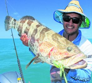Renegade deckie Kye holding an impressive goldspot cod lured by a lumo coloured Lucanus jig.