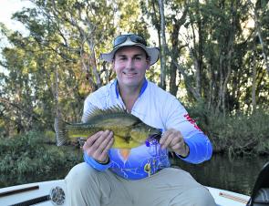 Simon __________ from Boats and More was a very willing participant in this boat test. He nailed this neat golden perch on a spinnerbait wile we were poking around the timber of Mulwala.