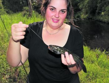 Hayley Mcdonald with a river black fish. These little natives should be handled with care and returned carefully to the pristine waterways in which they live.