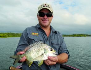 Lake Macquarie bream specialist Glenn Helmers with an average bream taken in only 30cm of water. 