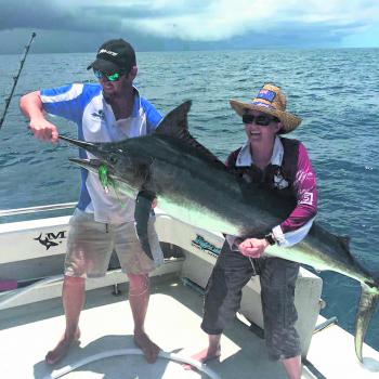 Renegade skipper Luke helps customer Kristyn Zell hold her prize catch caught trolling a custom bronze skirt. Marlin are still on offer this month.