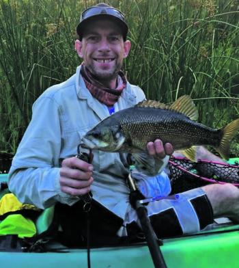 Malcolm Scott with a healthy bass caught off the surface on a cicada at Uki. 