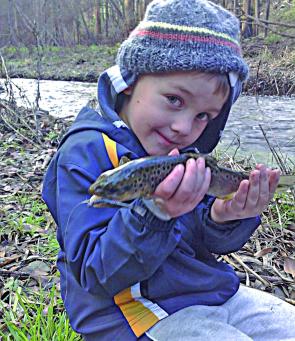 Lochie Thompson holding up a small brown trout from Traralgon creek on the closing weekend which he caught on a GULP! 2.5 inch minnow.