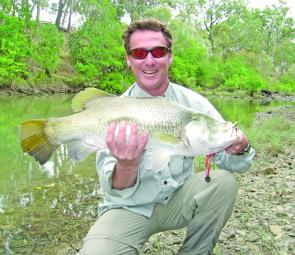 The author with his 65cm barra caught on a 50mm suspending C’ultiva minnow in a translucent green colour.