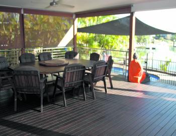 An eight seat table awaits diners on the outer deck. 