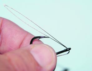 Start folding the wire back towards the hook point whilst still holding the tag end securely against the shank.
