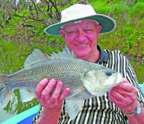 Graham Smith with one of several bass he caught while casting and trolling lures in the Brisbane River.