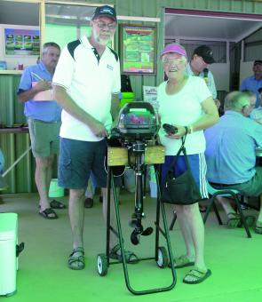 Barney from Barney’s Marine presenting a lucky draw winner, Marlene Cooke of Cooroibah, with a Suzuki Outboard motor sponsored by Barney’s Marine and Suzuki Outboards.