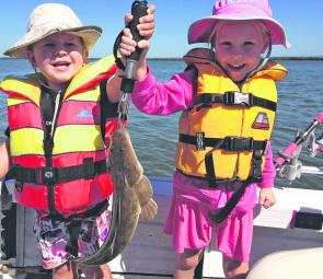 A family day out on the Passage yields many flathead. This one was taken on a hardbody lure by the kids –their smiles say it all!