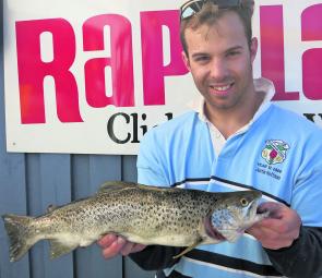 Justin Hoffman with a 52cm brown trout caught fly fishing on the lake using a Steve Williamson Snowy Mountains gold fish fly.