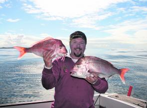 The author with a pair of solid reds destined for the barbecue part of 14 snapper caught for the morning.