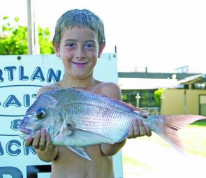 Scott Casey with his snapper, taken while fishing off the Lee Breakwall.