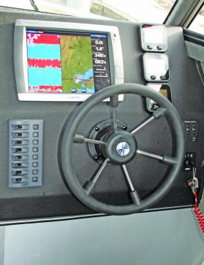 The uncluttered control area contains a flush mounted Garmin sounder GPS system.