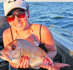 Jadee Carins with a schooling size snapper at 49cm caught on a Z-Man Curly Tailz in the natural colour.