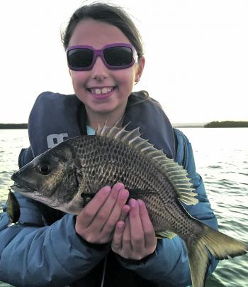 The author’s daughter Bella with her PB bream, caught on a Damiki DTSCO hardbody. She was over the moon with this 38cm fish.