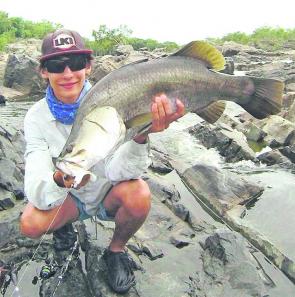 Luke Vella with an 80cm barra caught on a pearl white Z-man plastic near the upper tidal reaches of the Pioneer River.