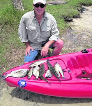 Andrew with a mixed bag of fish all taken on poppers from the kayak.