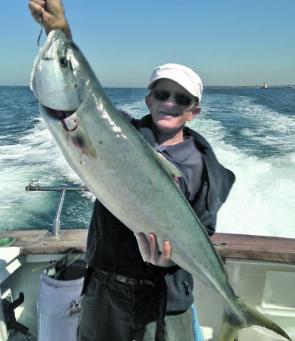 Happy customer aboard Rip Charters with a great kingfish.