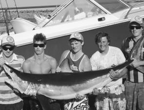 Travis Cole (second from left) caught this 100kg plus mako shark, after a fight that lasted 2.5 hours. 